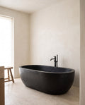 Vulcan stone bathing vessel in a wabi-sabi bathroom — Atelier Earthmade